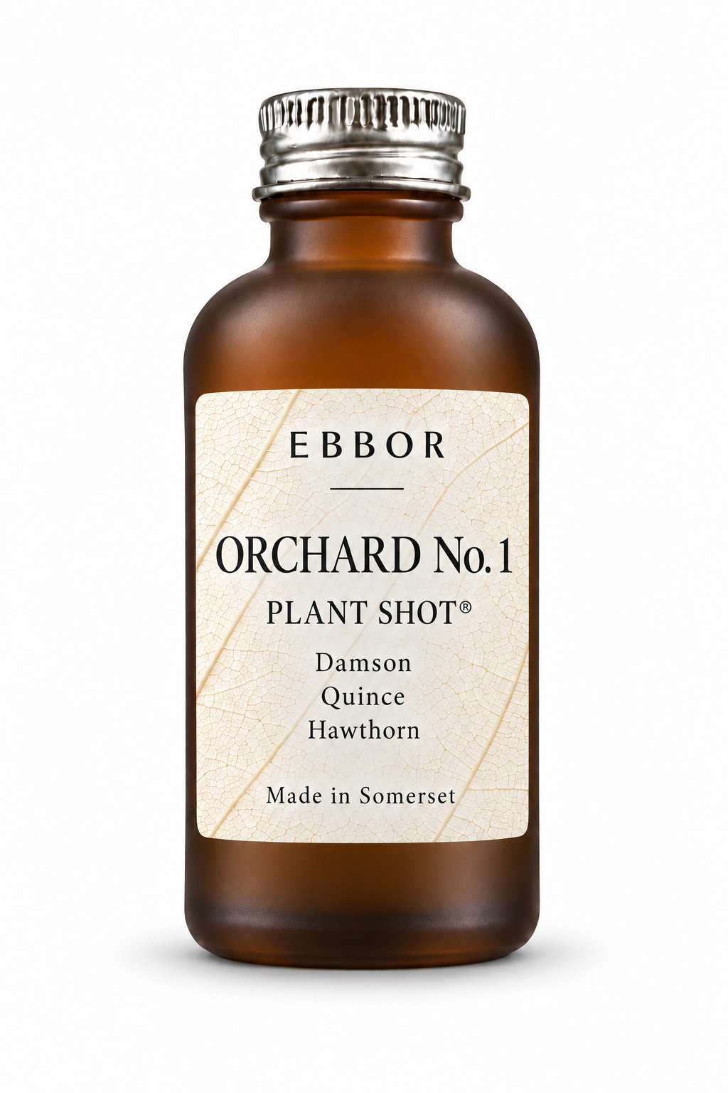 An amber glass Orchard No.1 Plant Shot bottle with a silver cap, standing on a seamless white ground with a soft shadow; its label reads Orchard No.1, Damson, Quince, Hawthorn, Made in Somerset