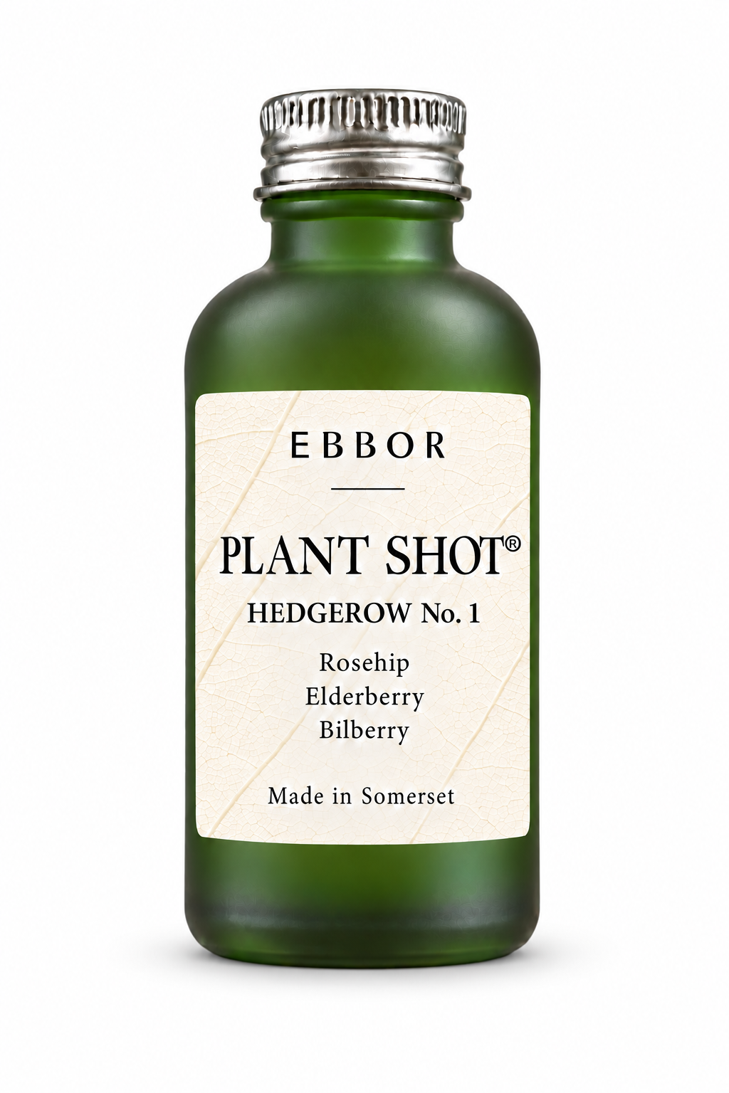 A frosted deep green glass Ebbor Plant Shot bottle with a ridged silver cap, standing on a seamless white ground; its ivory label carries a leaf-vein pattern and reads Hedgerow No.1, Rosehip, Elderberry, Bilberry, Made in Somerset