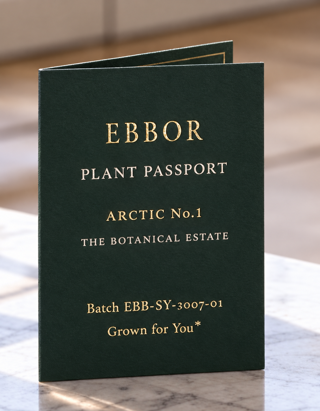 A dark-green Ebbor Plant Passport for Arctic No.1 standing on a marble counter