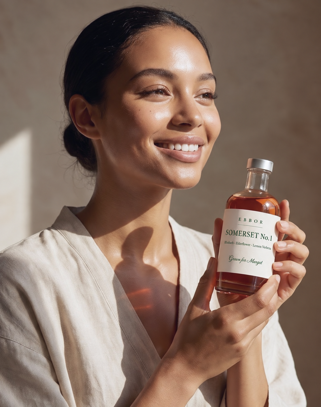 A woman holding a bottle of Ebbor Somerset No.1 — Rhubarb, Elderflower and Lemon Verbena, grown for Margot