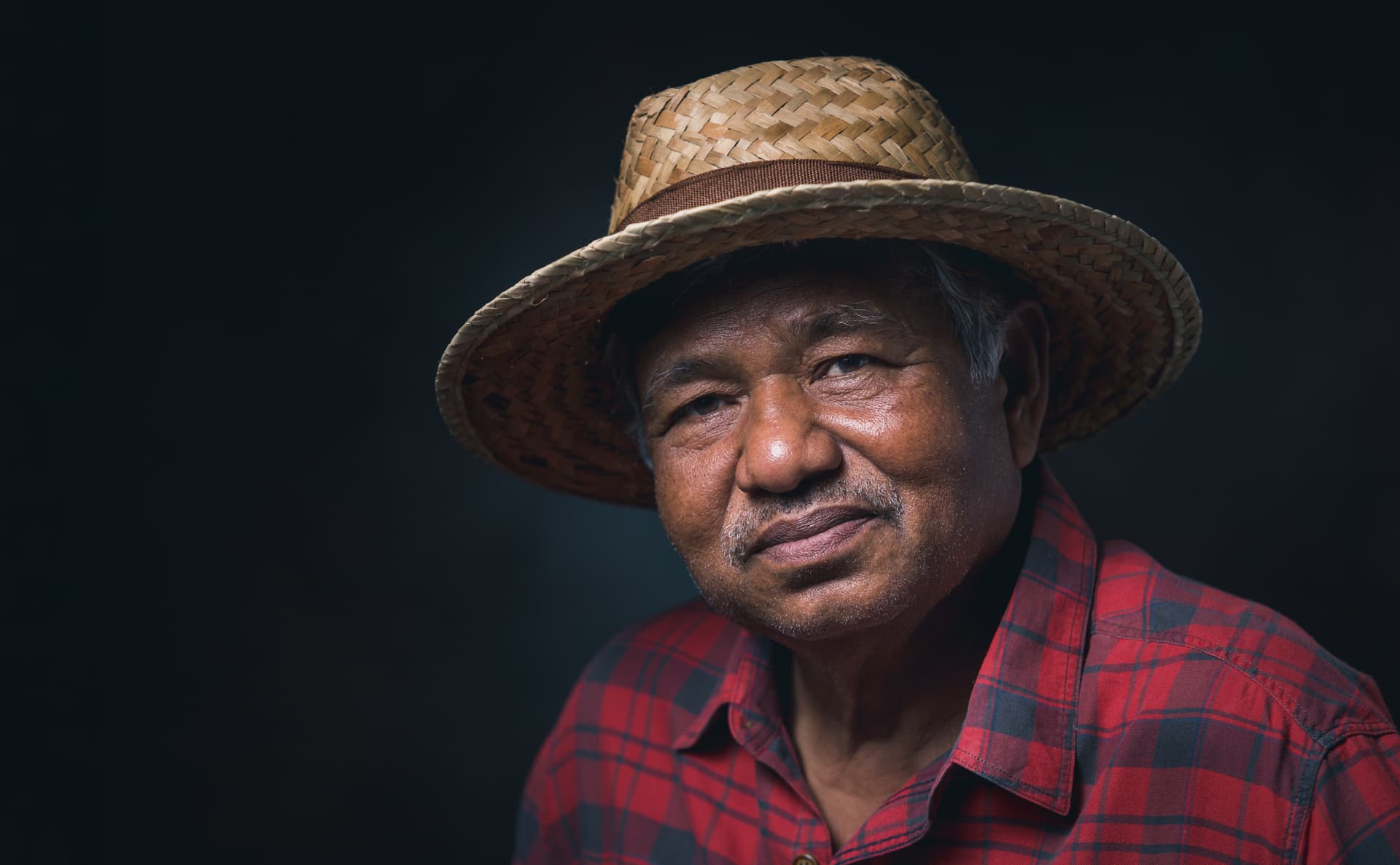 A grower standing among fruit trees on their own land